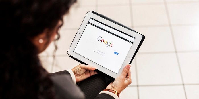 businesswoman on tablet using google search