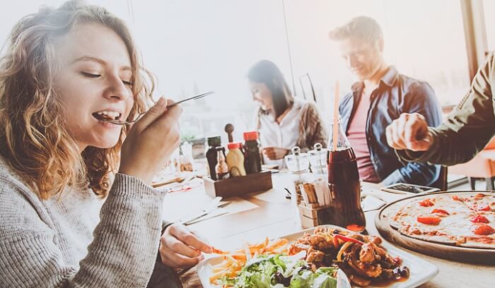 woman eating at restaurant with friends