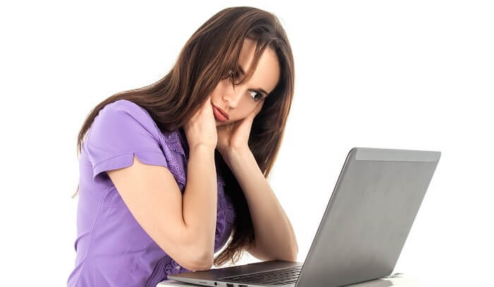 anxious young woman looking at computer