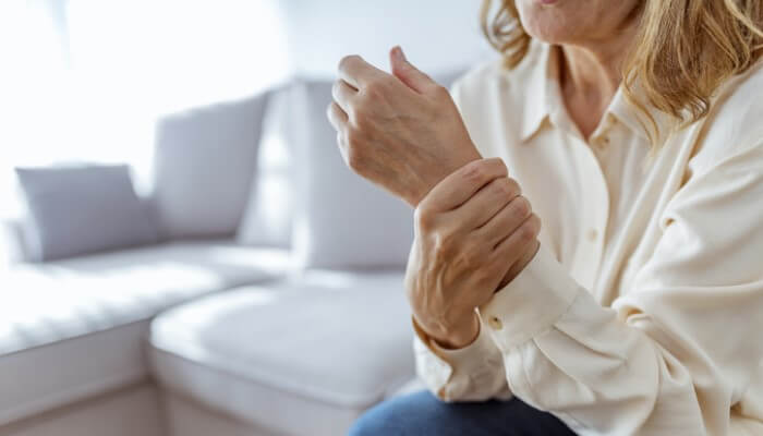 senior woman holding wrist in pain