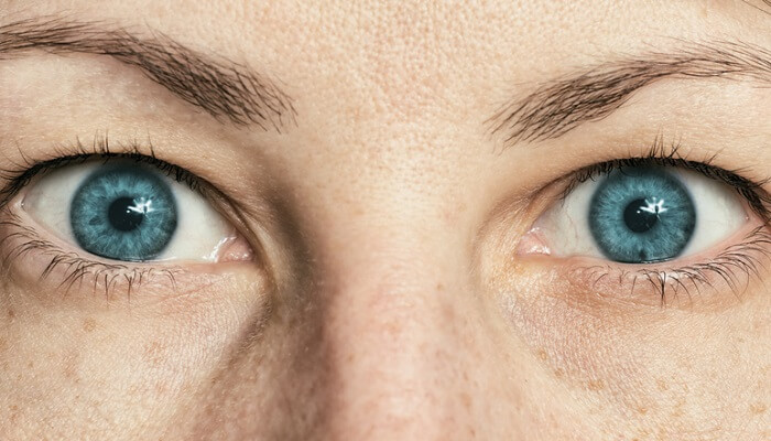 closeup of woman's eyes with blue iris