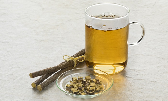licorice root next to cup of tea