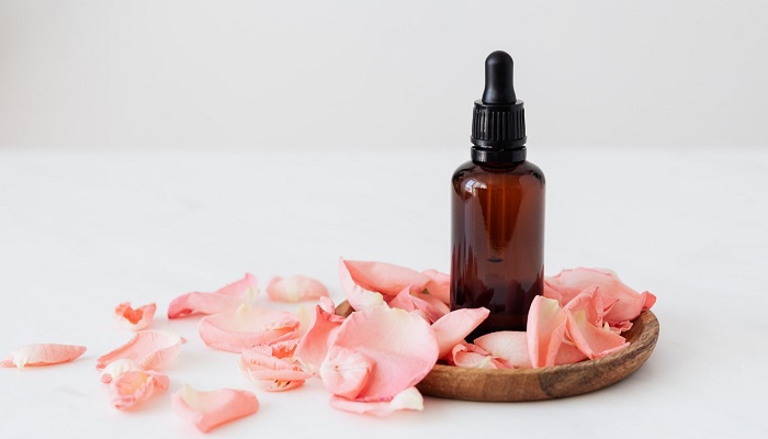 rose petals and oil bottle expensive essential oils